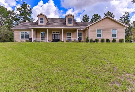 A large house with a lawn in front of it  Description automatically generated with medium confidence